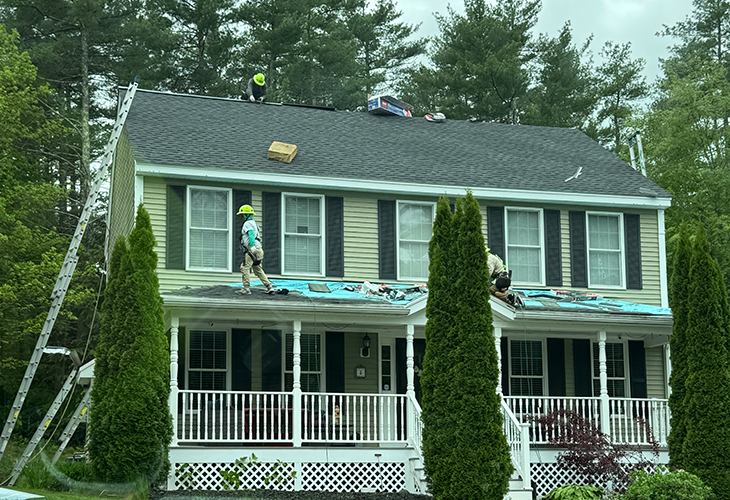Roofers working on a residential roofing project